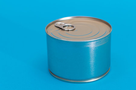 Tin Can on Blue Background. Canned Food. Aluminum Can for Safe and Long Term Storage of Food. Steel...