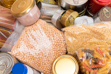 Donation Box of Free Food. Carton Box with Canned Food, Cereals and Grocery. Meal Reserves. Emergency Food Storage in Case of Crisis. Free Social Help, Blessings and Care. Strategic Food Suppliesの写真素材