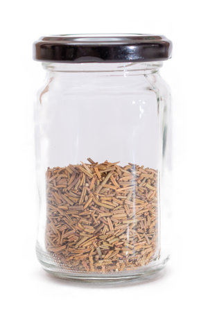 Rosemary Seasoning in a Small Glass Jar Isolated on White Backgroundの写真素材