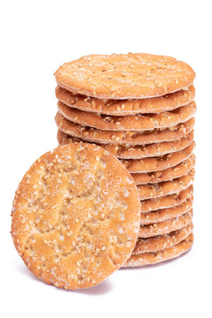 A Stack of Round Salt Crackers with Sesame Isolated on White Background. Dry Snacks - Isolationの写真素材