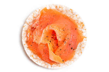 Tasty Rice Cake Sandwich with Fresh Salmon Slices Isolated on White - Top View. Easy Breakfast and Diet Food. Crispbread with Red Fish. Healthy Dietary Snack - Isolationの写真素材