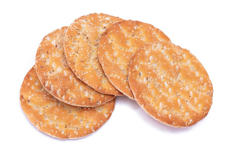 A Heap of Round Salt Crackers with Sesame Isolated on White Background. Dry Snacks - Isolationの写真素材