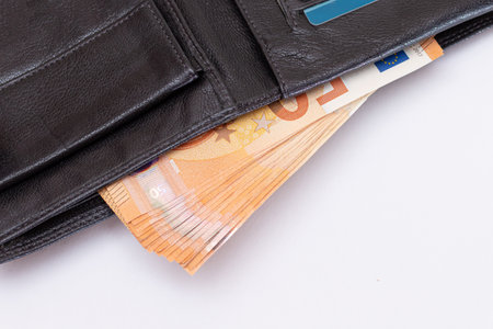 Opened Black Leather Men Wallet with Fifty Euro Banknotes and Bank Cards Inside on White Background....