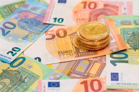 A Stack of Coins on the Euro Banknotes. Money Saving, Cryptocurrency, Blockchain and Anonymous Payments Conceptの写真素材