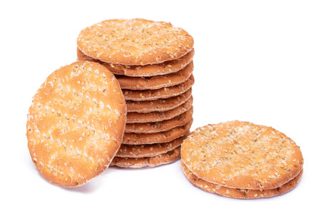A Stack of Round Salt Crackers with Sesame Isolated on White Background. Dry Snacks - Isolationの写真素材