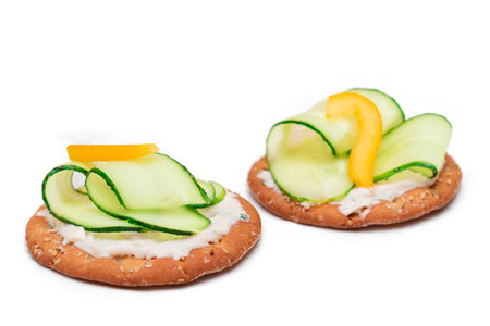 Crispy Cracker Sandwich with Fresh Cucumber, Yellow Paprika and Cottage Cheese - Isolated on White. Easy Breakfast. Quick and Healthy Sandwiches. Crispbread with Tasty Filling.の写真素材