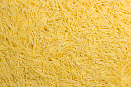 Uncooked Filini Pasta: A Culinary Canvas of Noodles, Creating a Lively and Textured Background for Gourmet Cooking. Dry Pasta. Raw Macaroni - Top View, Flat Layの写真素材
