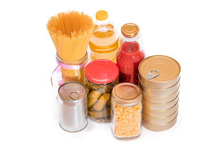 Food Reserves: Canned Food, Spaghetti, Pate, Tuna, Tomato Juice, Pasta, Fish and Grocery - Isolated on White Background. Emergency Food Storage in Case of Crisis. Strategic Food Supplies - Isolationの写真素材