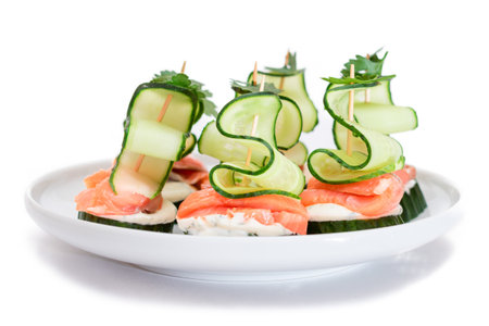 Canapes without Bread with Fresh Salmon, Cucumber and Cream Cheese - Isolated on White Background. Easy Breakfast. Diet Food. Quick and Healthy Sandwiches. Healthy Snacks with Tasty Fillingsの写真素材