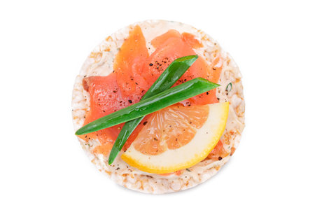 Rice Cake Sandwich with Fresh Salmon, Lemon and Green Onions - Isolated on White Background. Diet Food. Quick and Healthy Sandwiches. Crispbread with Fresh Fillings. Healthy Dietary Snackの写真素材