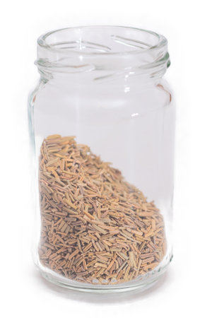 Rosemary Seasoning in a Small Glass Jar Isolated on White Backgroundの写真素材
