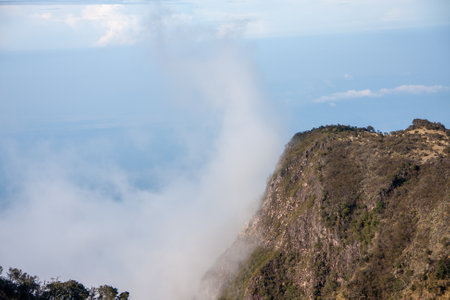 Mountain landscape with fog and cloudsの写真素材