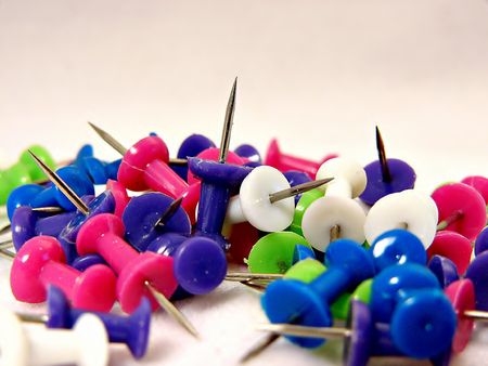 Brightly Colored Push-Pins on a White Backdropの写真素材