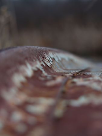 very shallow depth of field of the bottom of a rusty boatの写真素材