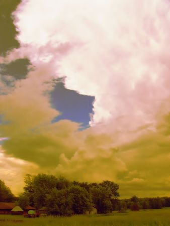 An eerie looking sky with the colors of an approaching stormの写真素材