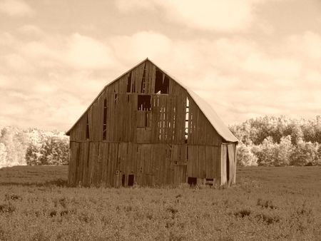 An old Barn, weathered and aged, in sepiaの写真素材