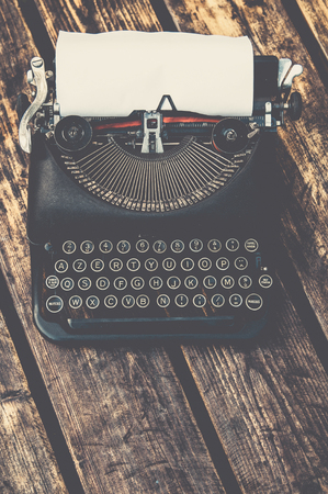 Vintage typewriter in on a wooden tableの写真素材