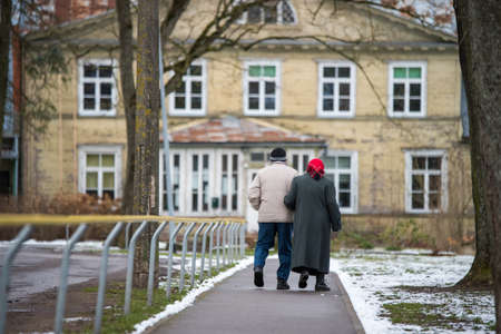 Two elderly senior people are walking on road.のeditorial素材