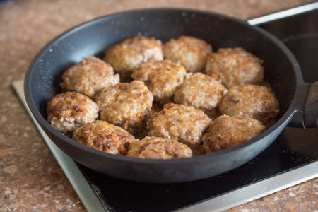 Fried cutlets in a frying pan on the stove