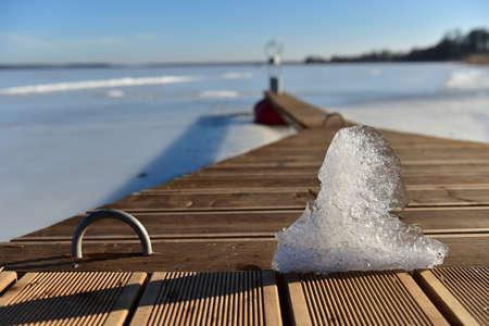 Chunk of ice in frozen lake background