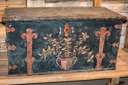 Old wooden chest against wooden wallの写真素材