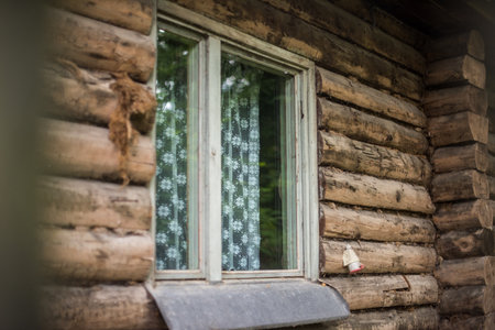 Old European wooden window with lace curtains.の写真素材