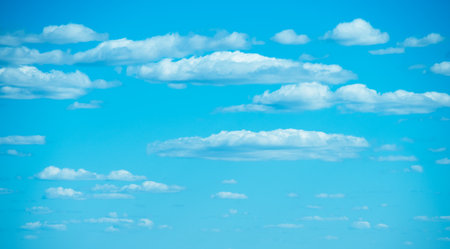 Blue sky covered with small white clouds.の写真素材