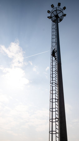 tower of the high - rise power station against a cloudy blue sky