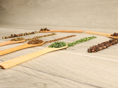 Spices in wooden spoons on wooden background. Selective focusの写真素材