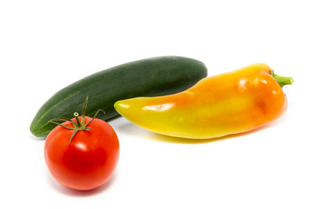 vegetables on a white background. tomatoes, peppers and cucumbersの写真素材