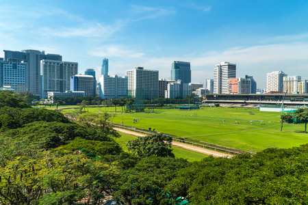 BANGKOK - JANUARY 19, 2017: Bangkok Cityscape, business district with high building and golf field at sunshine day on january 19, 2017 in Bangkok, Thailand.のeditorial素材