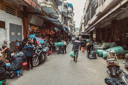 HANOI, VIETNAM - DECEMBER 14, 2018 : Street scene of the Old Quarter of Hanoi. Local daily life of the morning street market, street vendors selling various types of goods.のeditorial素材