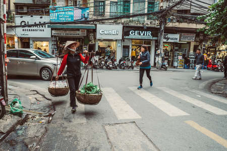 HANOI, VIETNAM - DECEMBER 14, 2018 : Street scene of the Old Quarter of Hanoi. Local daily life of the morning street market, street vendors selling various types of fruits and vegetablesのeditorial素材