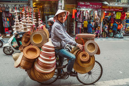 HANOI, VIETNAM - DECEMBER 14, 2018 : Street scene of the Old Quarter of Hanoi. Street vendor selling...