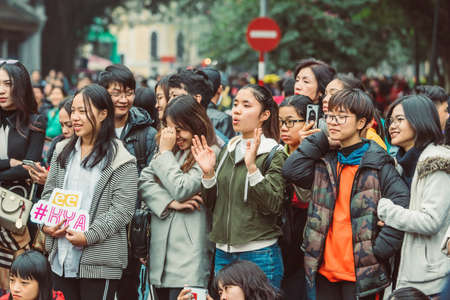 HANOI, VIETNAM - DECEMBER 15, 2018 : Street scene of the Old Quarter of Hanoi during the day. Lots of young people in the watching street show.のeditorial素材