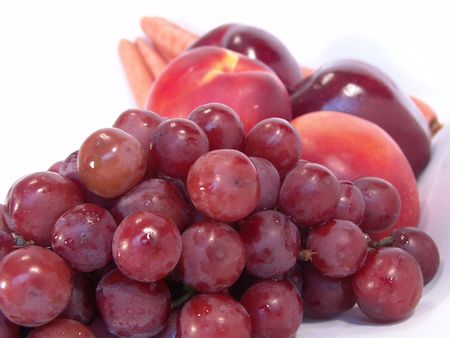 A bunch of fruit and vegetable, including, carrot, apple, apricot and grapesの写真素材