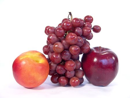 A bunch of fruit, including, apple, apricot and grapesの写真素材
