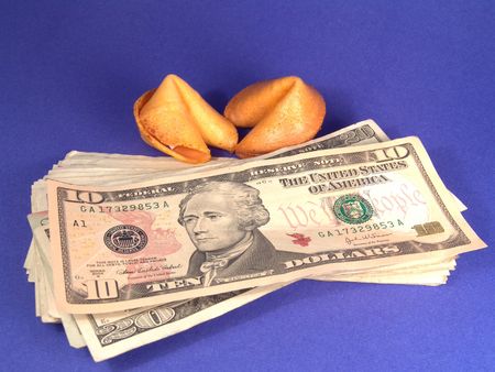 Ten dollar United States bill with George's face and a fortune cookie.の写真素材