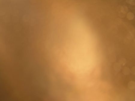 A smooth rusty brown background with a flash of light in the middleの写真素材