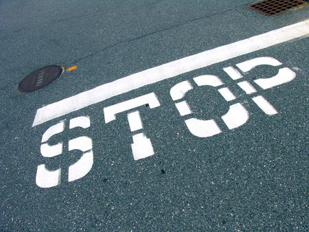 A big traffic stop sign painted on the road surface                               の写真素材