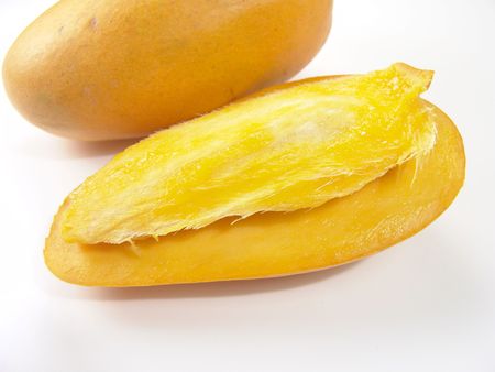 Sweet juicy champagne mango slice close-up with seed                               の写真素材