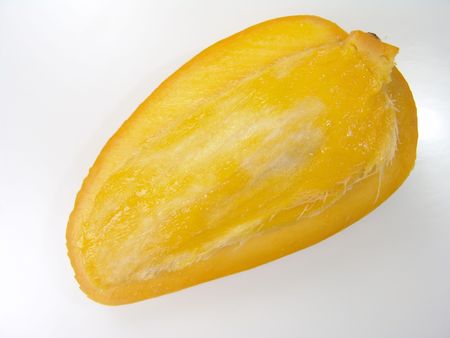 Sweet juicy champagne mango slice close-up with seed                               の写真素材