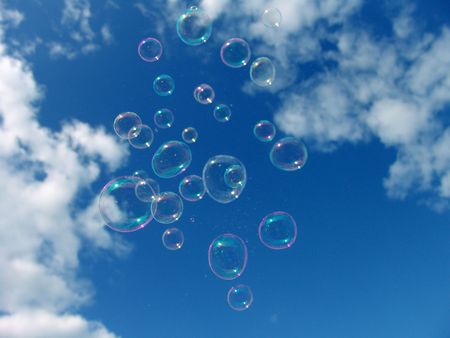 Colorful Soap Bubbles Against Blue Sky Background                               の写真素材