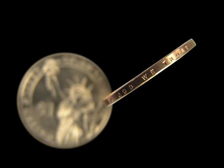 Isolated United States 2007 One Dollar Coin Side View Macro Close-up (Engraved In God We Trust) with out of focus Statue of Liberty at the back                               の写真素材