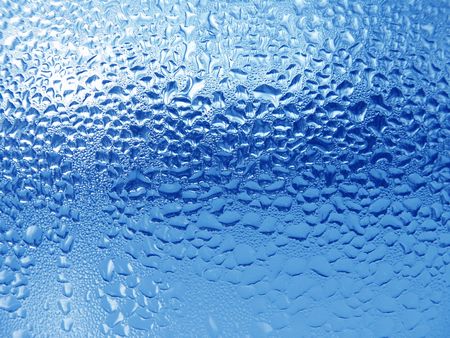 Close-up clear drops of water on window glass surface                               の写真素材