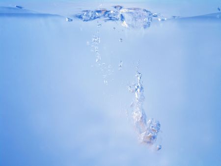 Close-up of water waving and splashing caused by dropping objects                               