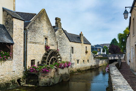 Bayeux, France - September 2, 2016: Scene of Bayeux with a waterway named the Aure and a watermillのeditorial素材