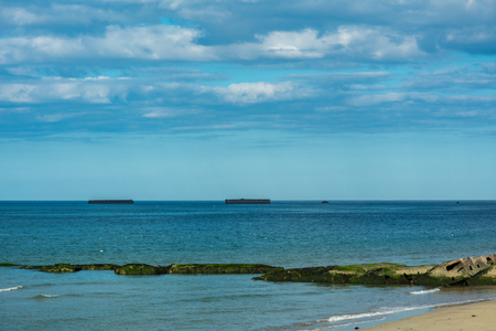 Arromanches is remembered as a historic place of the Normandy landings and in particular as the place where an artificial port was installed. This artificial port allowed the disembarkation of 9,000 tons of material per day.の写真素材