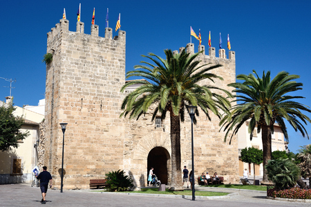 Alcudia, Majorca, Spain - September 5, 2013: The old town has a gate with two towers, a 14th-century wall and it is possible to step up on the wall and follow it almost all around the village.のeditorial素材