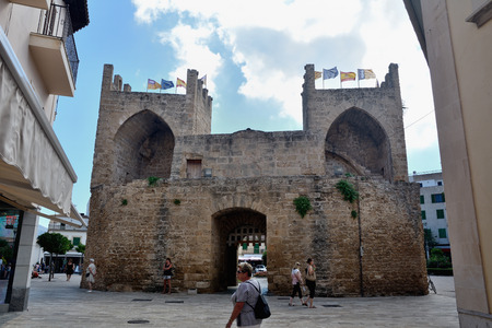 Alcudia, Majorca, Spain - September 5, 2013: The old town has a gate with two towers, a 14th-century wall and it is possible to step up on the wall and follow it almost all around the village.のeditorial素材